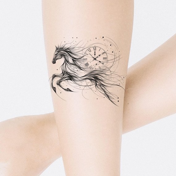 Various horse tattoo design sketches displayed on a clean artist workstation table.