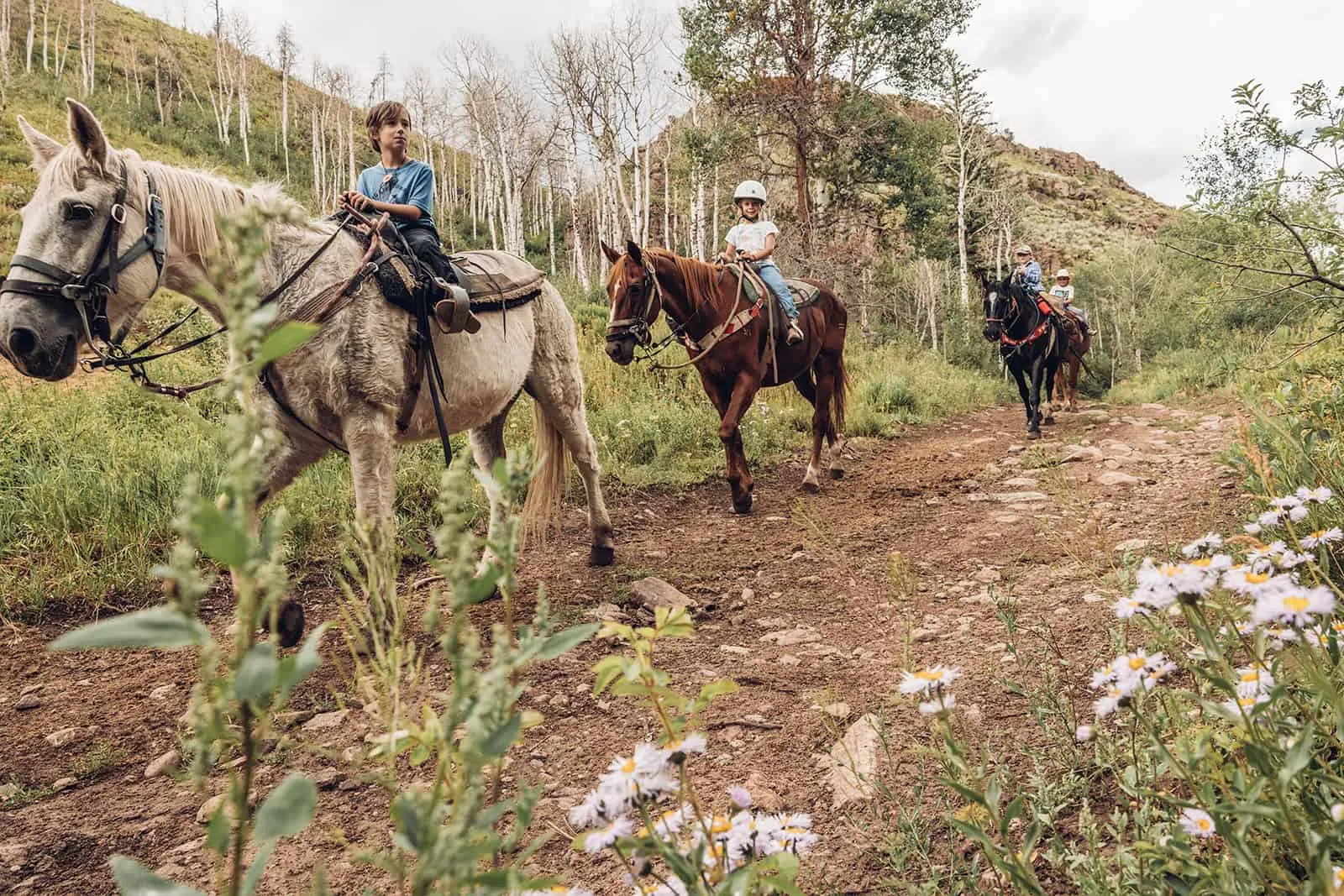 Cowboy boots and a fleece jacket prepared for a mountain horseback ride.