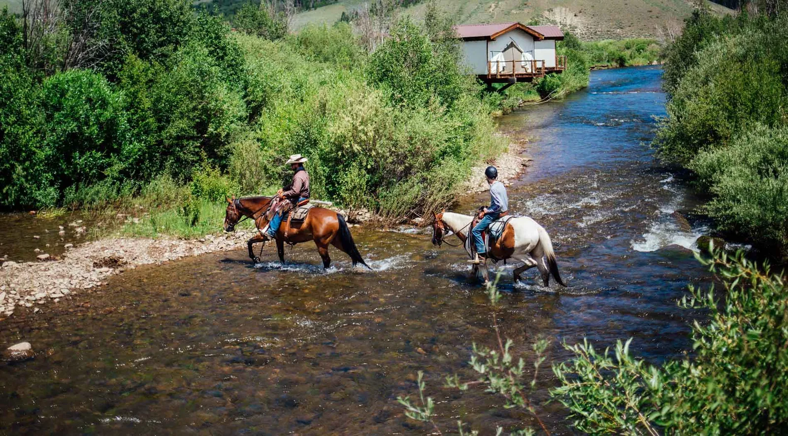 A person pays for a horseback riding adventure at a booking counter.