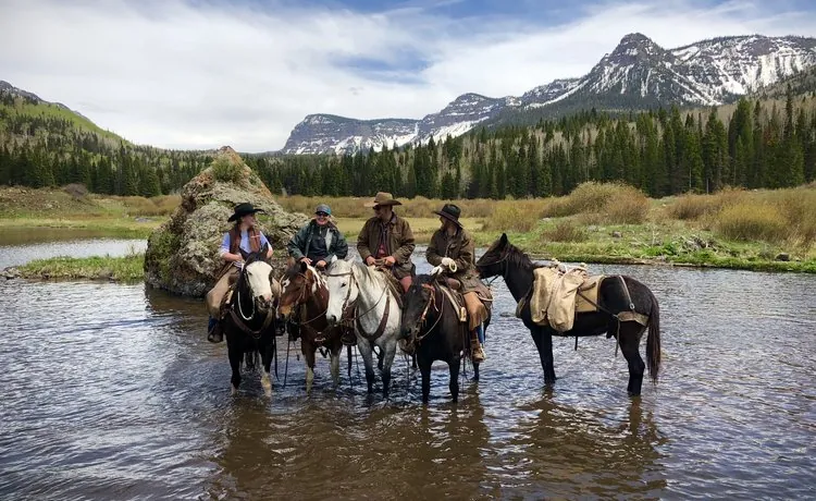 A trail guide reviews safety documents outside a Colorado horse stable.
